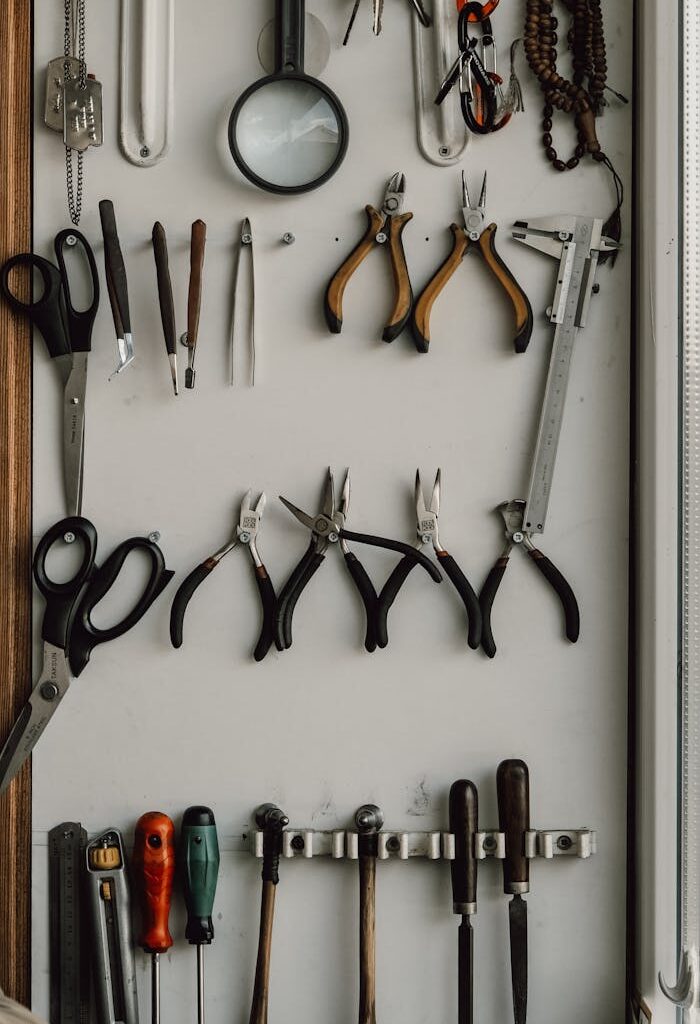 A neatly arranged wall display of hand tools in a workshop for DIY and repair work.
