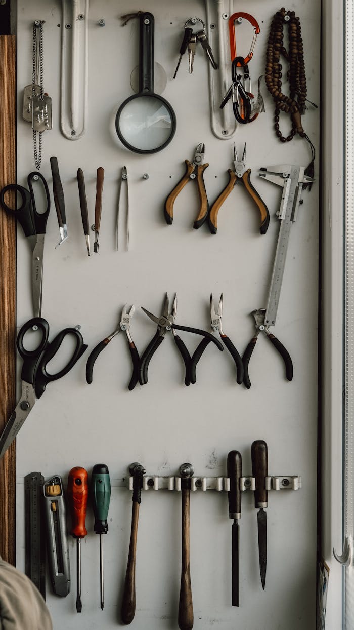 A neatly arranged wall display of hand tools in a workshop for DIY and repair work.