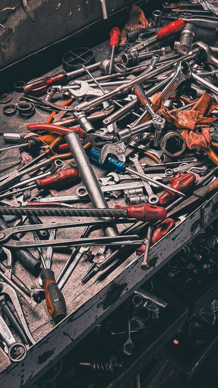 A cluttered workbench with various hand tools in a garage setting, vibrant and detailed.